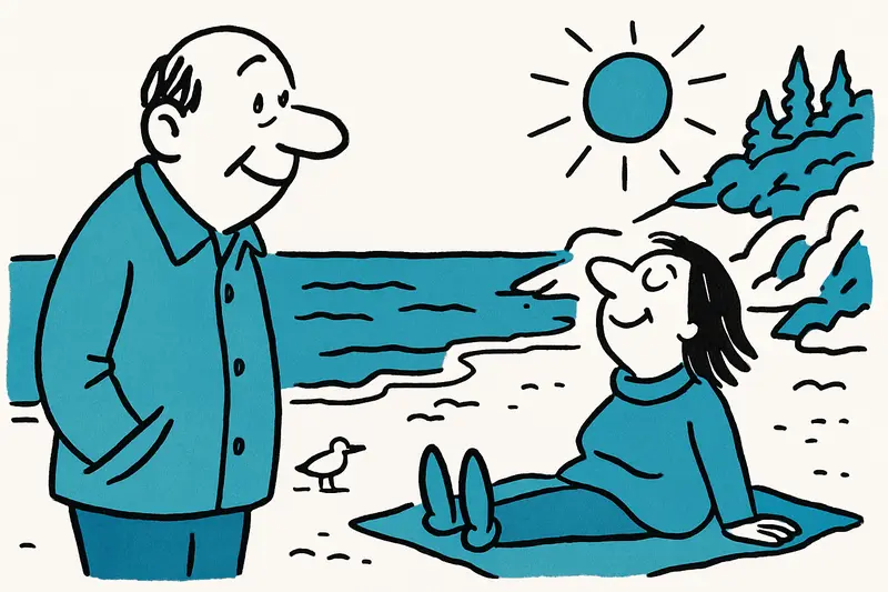 Sunlit secluded Mallorcan cove with sandy beach, calm turquoise sea and pine-covered cliffs in winter.